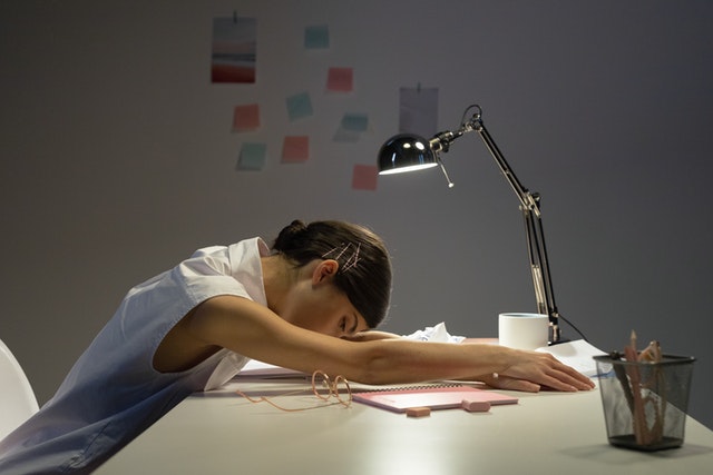 A woman sleeping at the desk