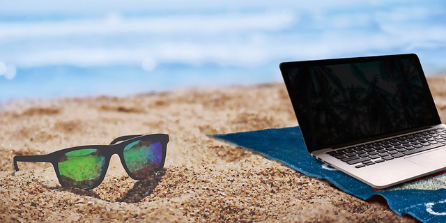 A laptop and sunglasses on the beach(Travel and learn to talk about it in Serbian!)