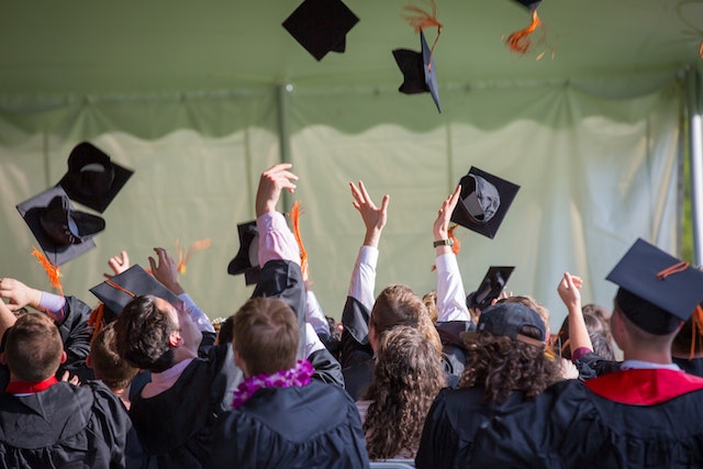 Students graduating and throwing their hats in the air.
(If you're talking about your major, it's correct to use the verb studirati!)
