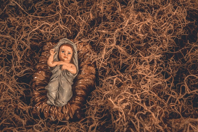 A figure of a baby Jesus on a hay.(Learning Serbian Christmas traditions - hay represents the stable where Jesus was born!)